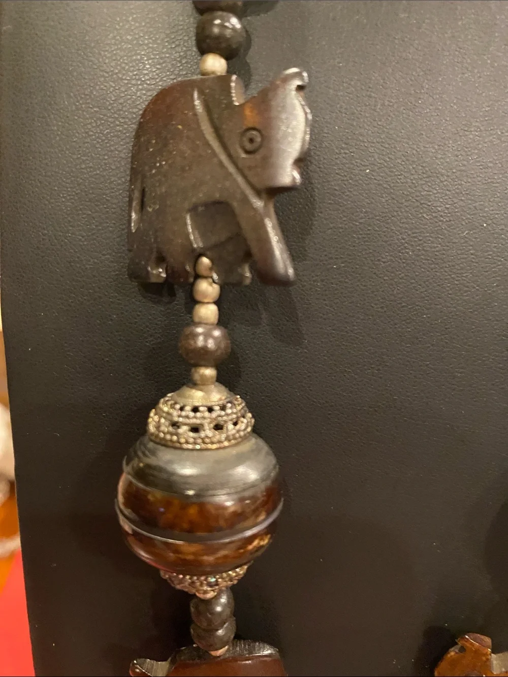 Handcrafted Elephant Pendant Necklace - Brown. Small elephants are bone.
